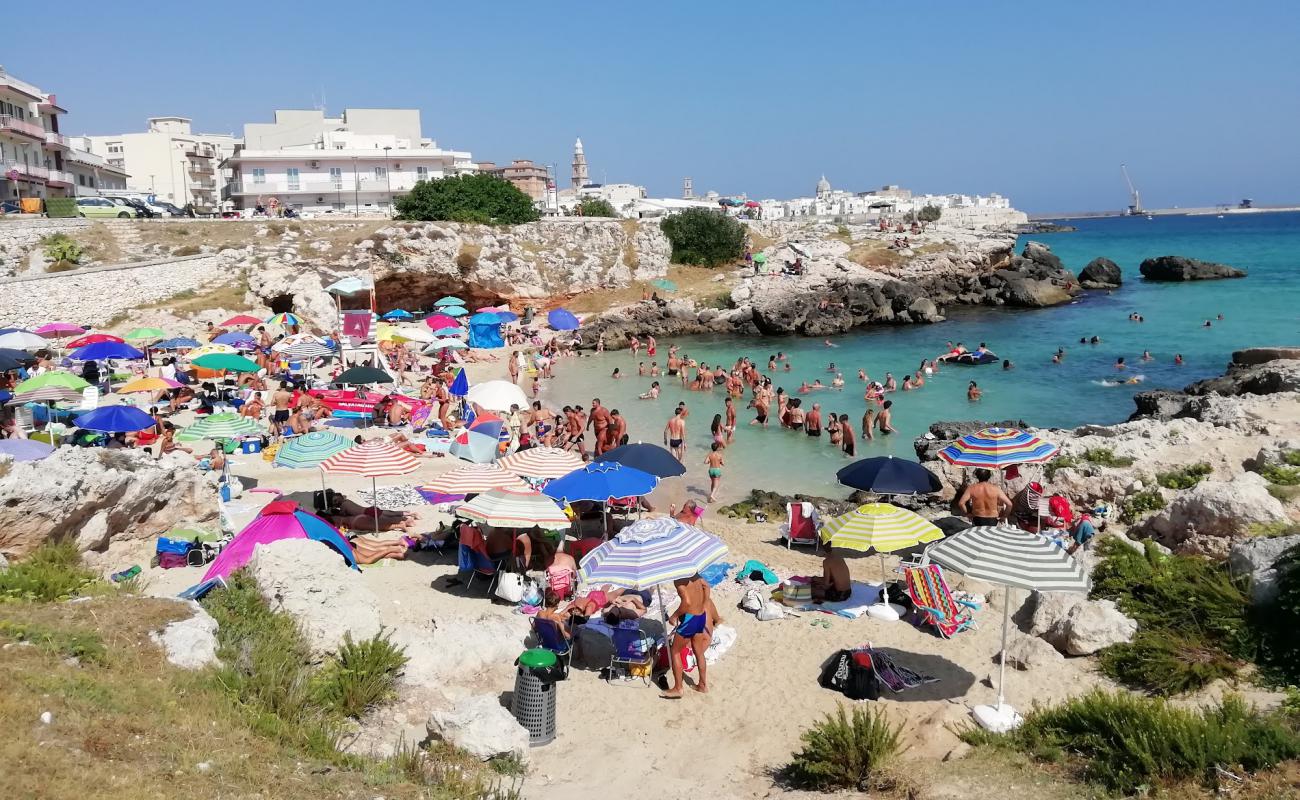 Photo of Spiaggia di Cala Porto Rosso with bright sand surface