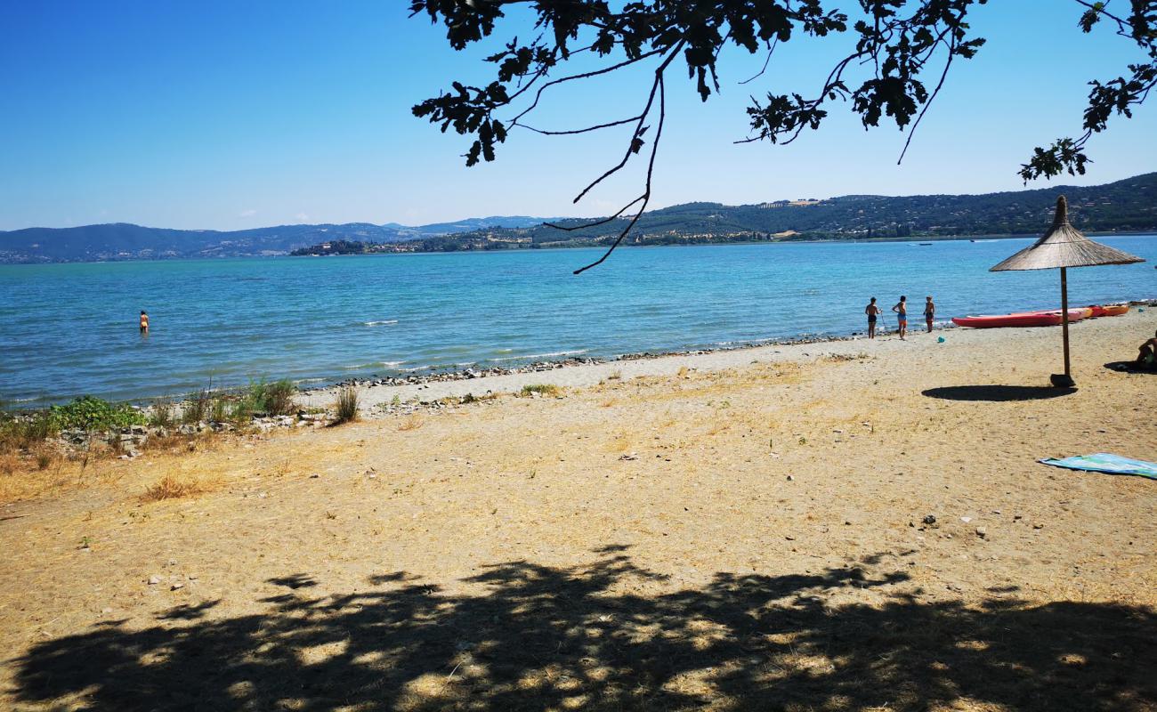 Photo of Spiaggia dell Isola Polvese with bright sand surface