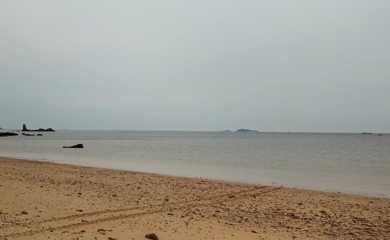 Photo of Duegi Beach with brown sand &  rocks surface