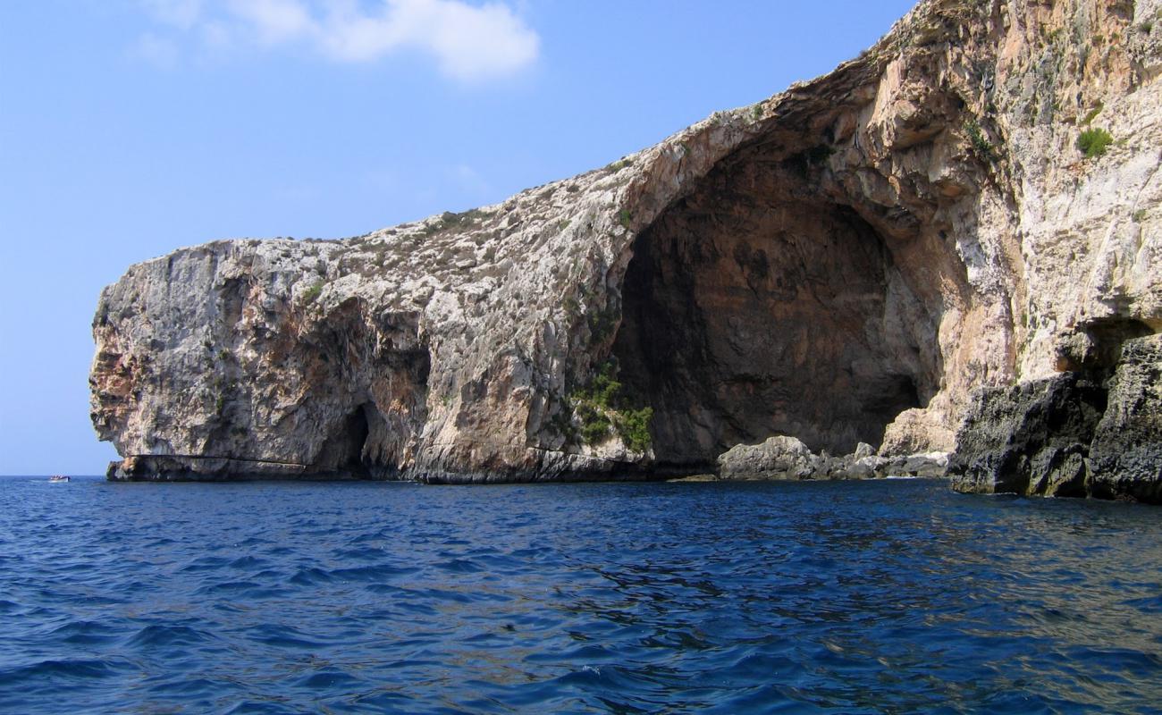 Photo of Blue Grotto beach with rocks cover surface