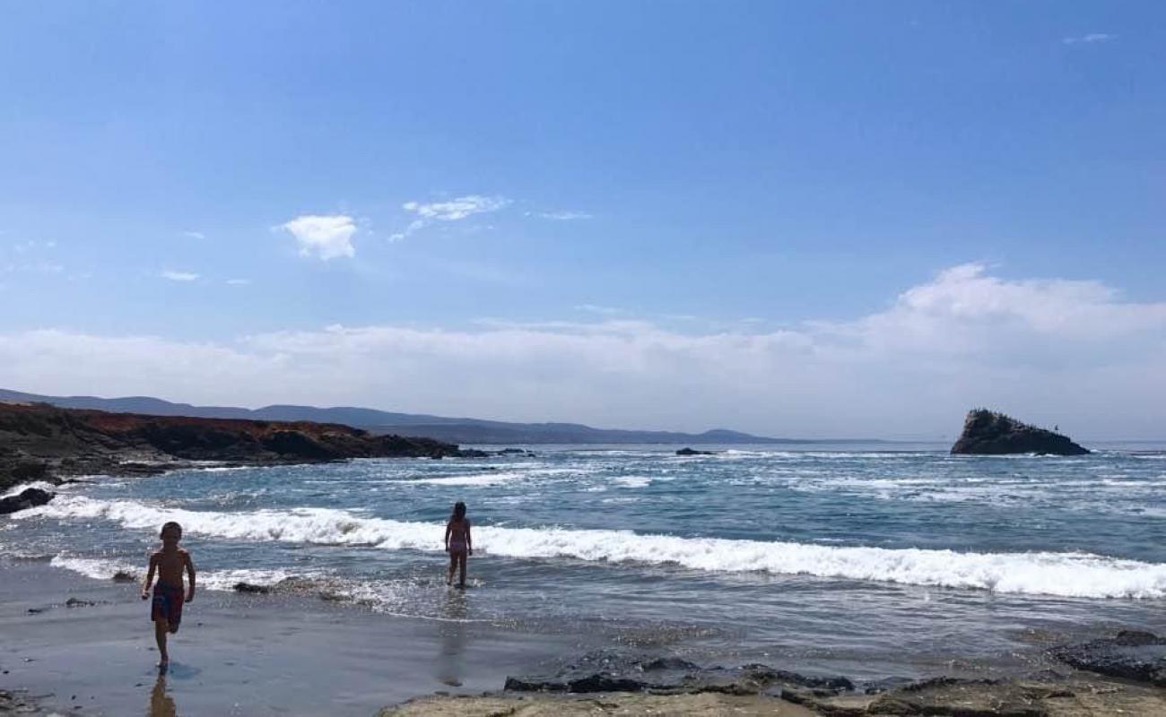 Photo of Playa Ejido Erendira with brown sand &  rocks surface