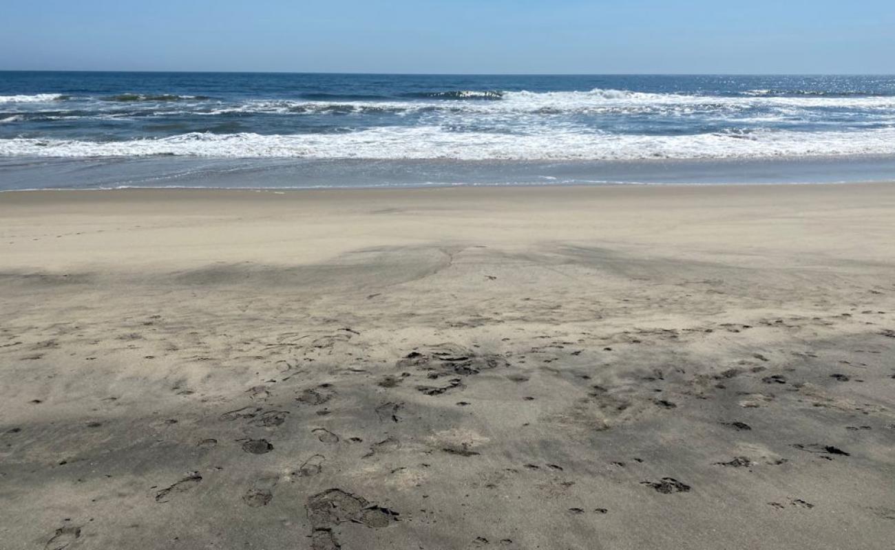 Photo of El Cunano beach with brown fine sand surface