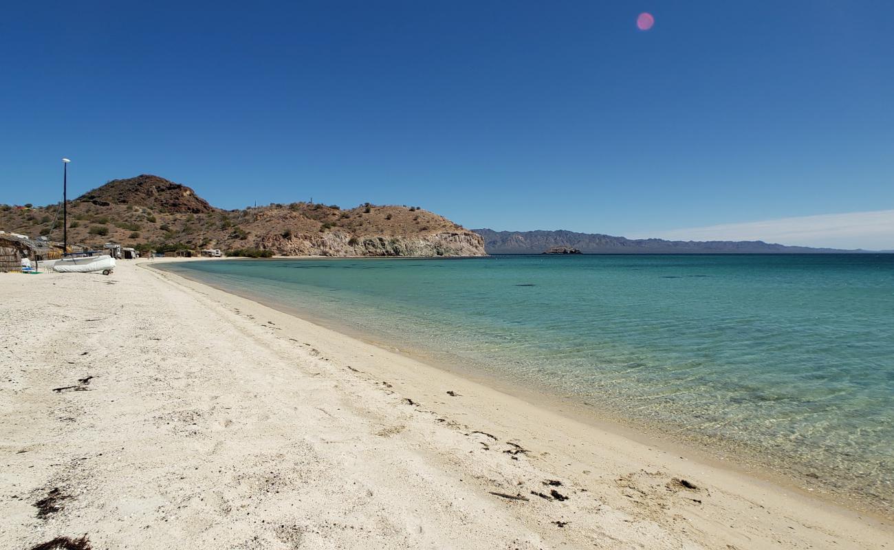 Photo of Playa Los Cocos with bright shell sand surface