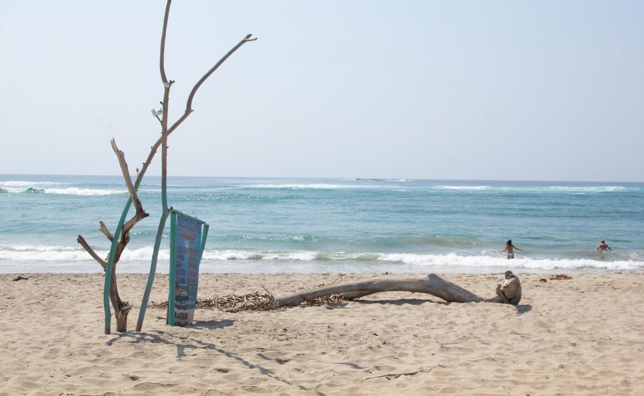 Photo of El faro de Chacahua with bright sand surface