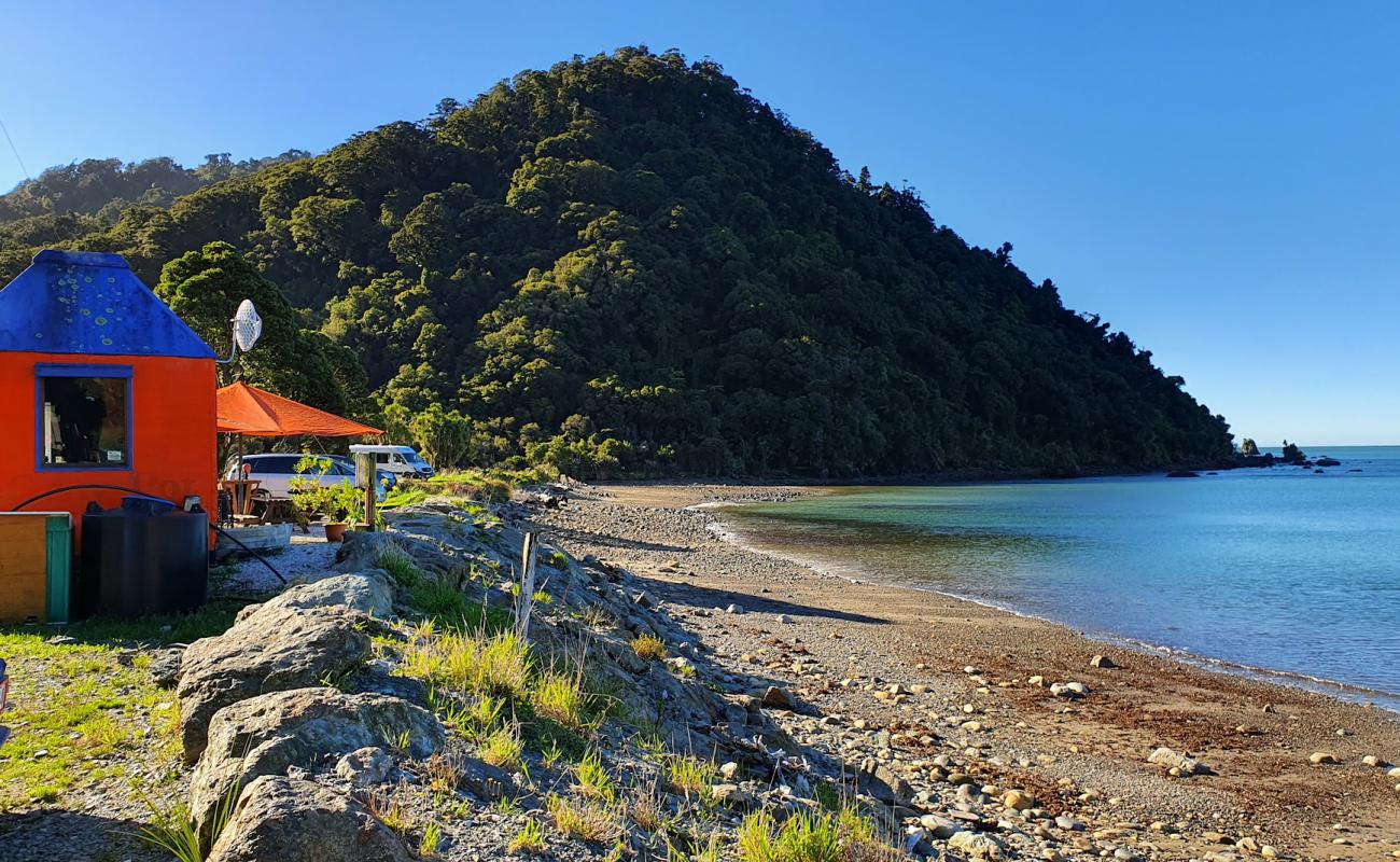 Photo of Neils Beach with black sand & pebble surface