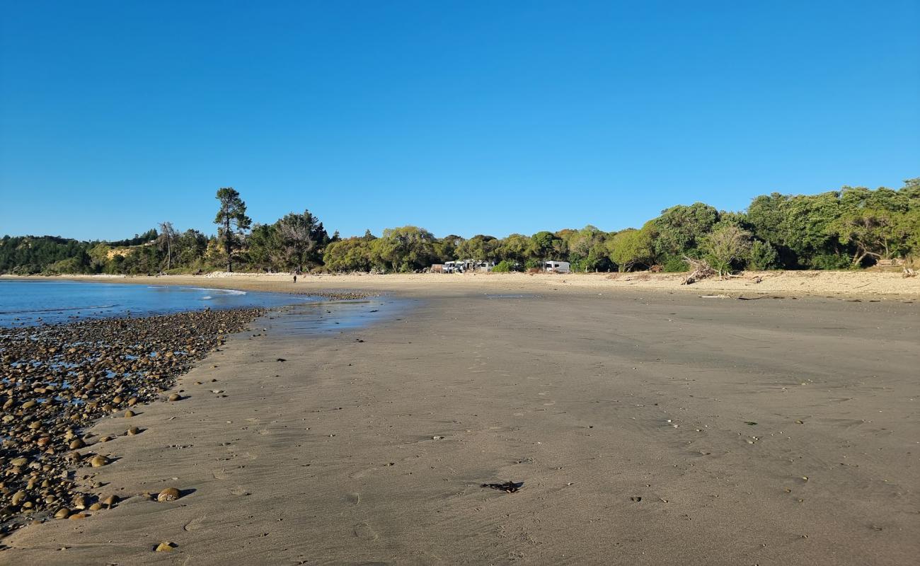 Photo of Kina Beach III with gray sand &  pebble surface