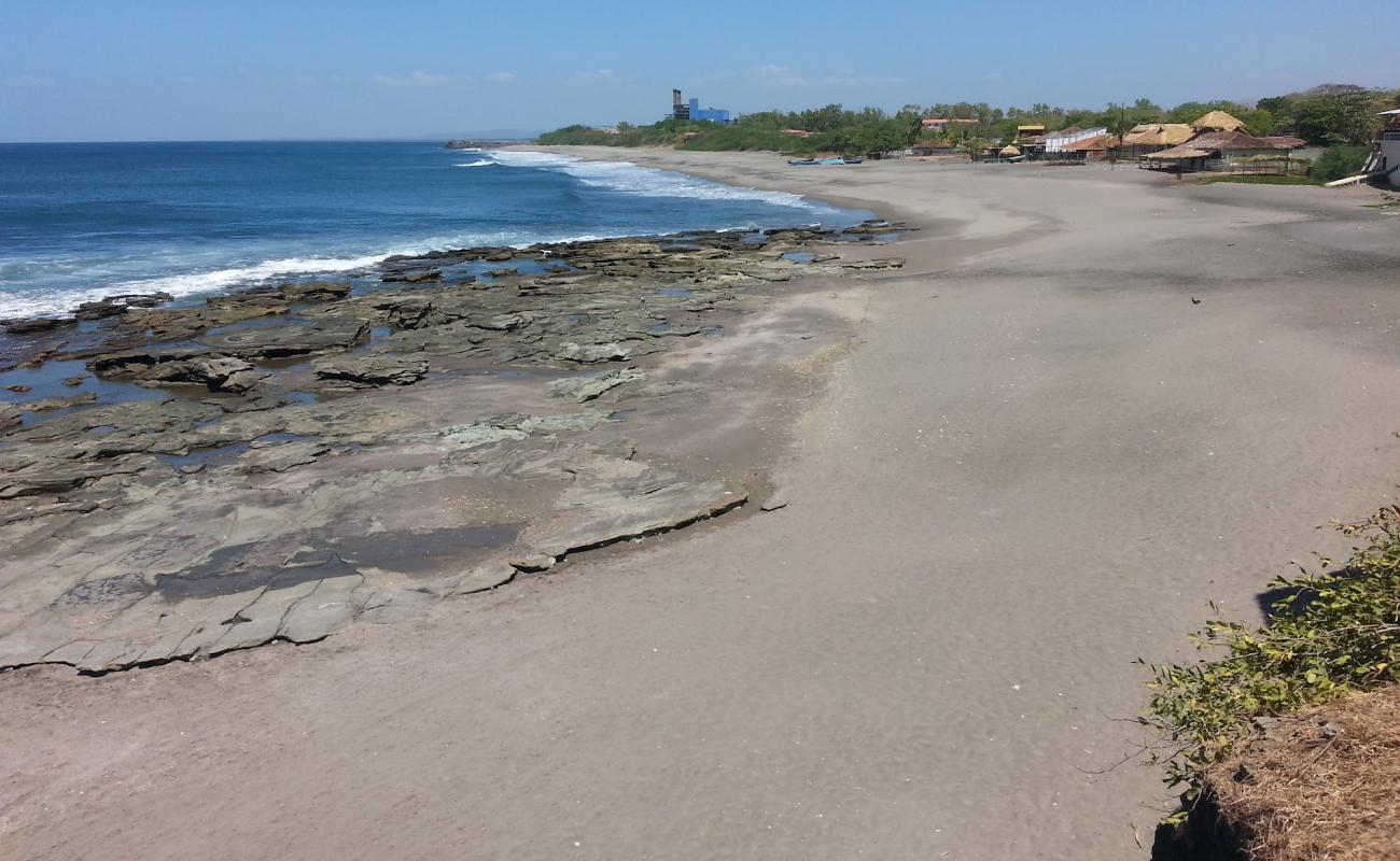 Photo of Miramar beach with gray sand &  rocks surface