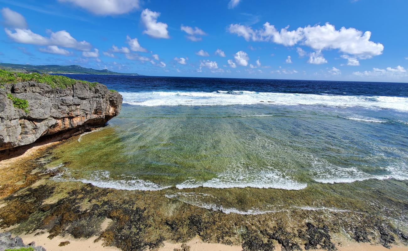 Photo of Marine Beach with bright sand & rocks surface