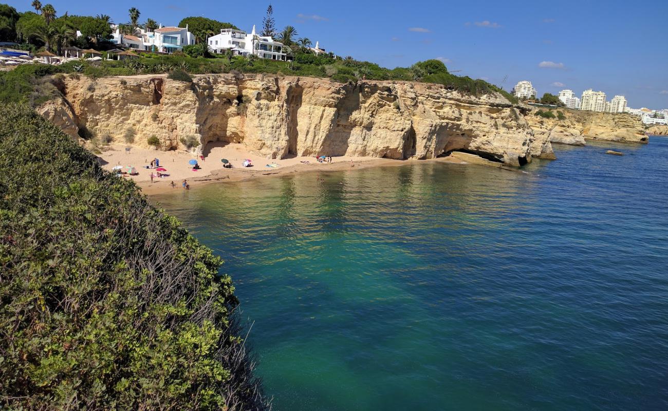 Photo of Praia dos Tremocos with brown fine sand surface