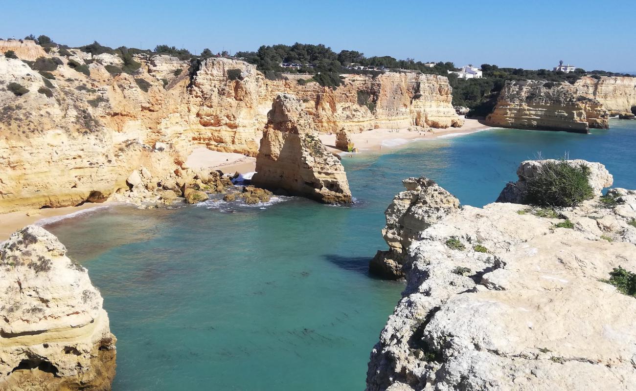 Photo of Marinha Beach with brown fine sand surface