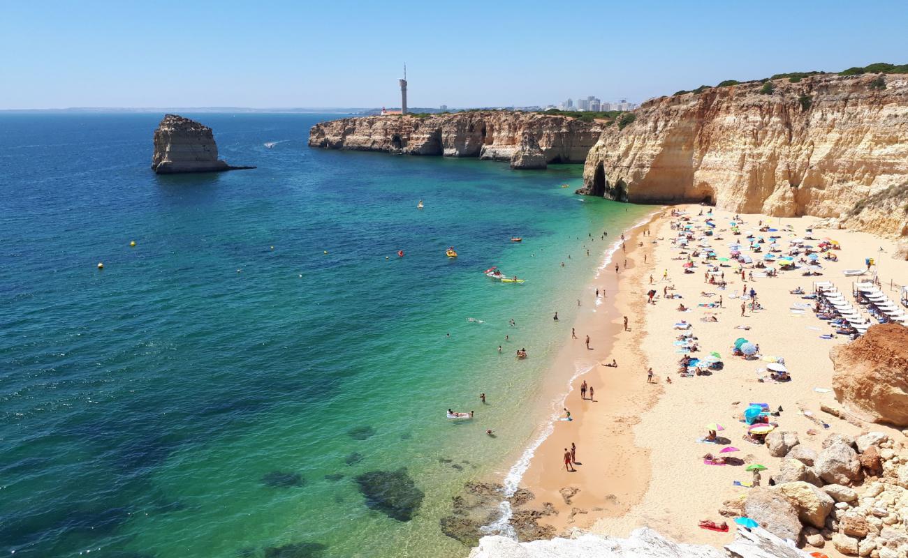 Photo of Praia dos Caneiros with brown fine sand surface