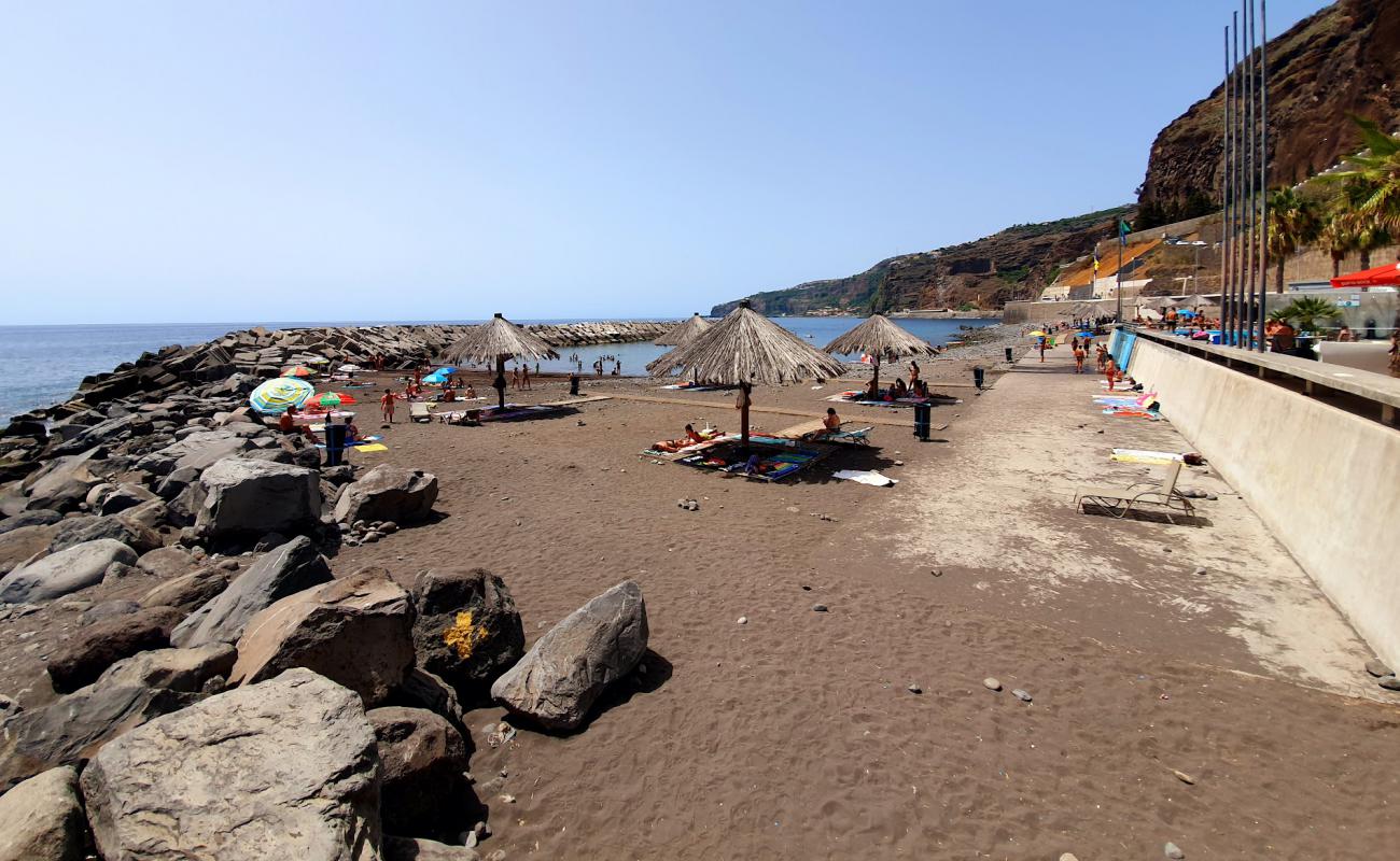 Photo of Praia Da Ribeira Brava with gray sand &  rocks surface