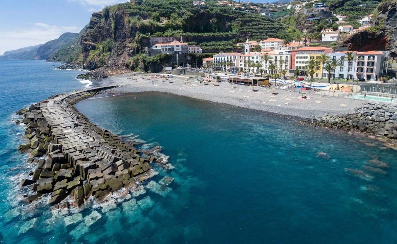 Photo of Praia da Madalena do Mar with gray sand &  rocks surface