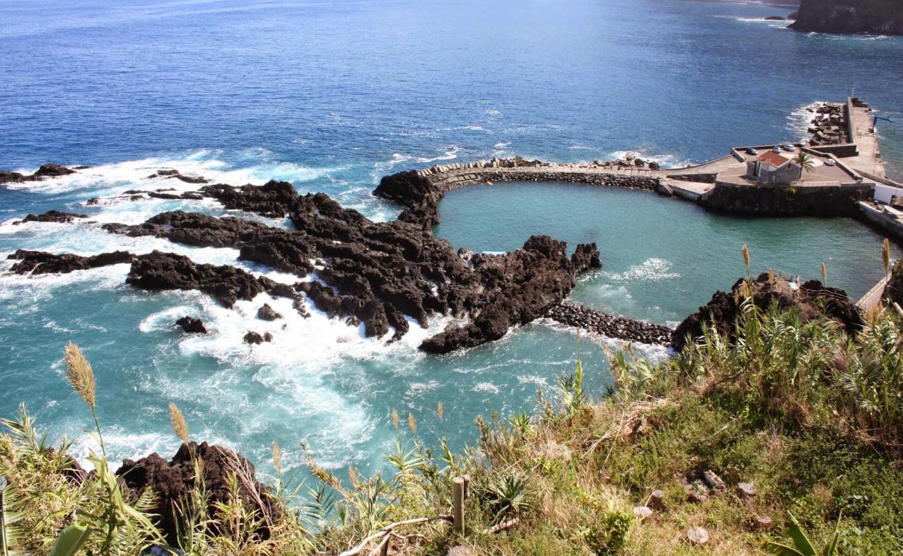 Photo of Natural public swimming pool with brown pebble surface