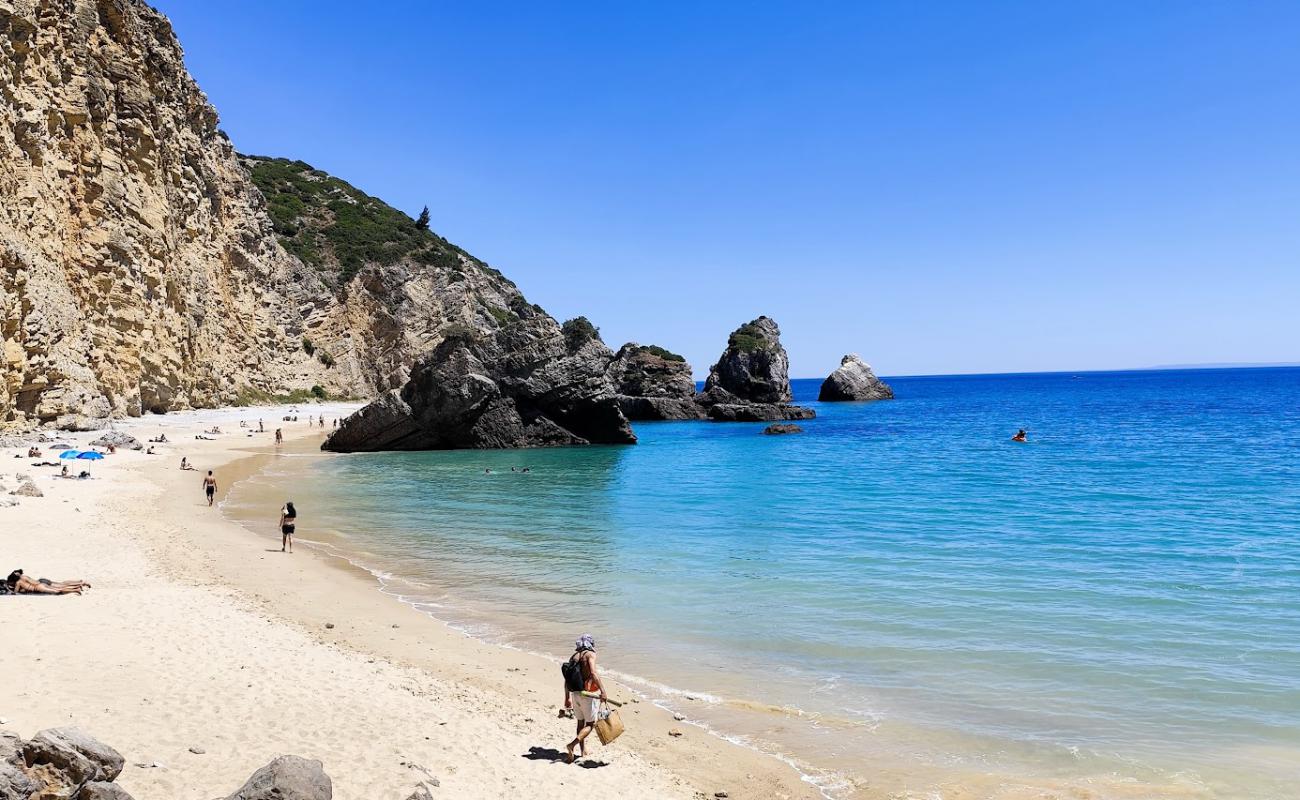 Photo of Praia do Ribeiro do Cavalo with bright sand surface