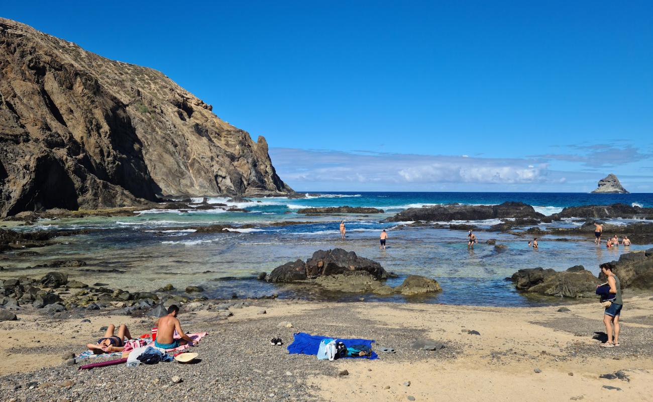 Photo of Porto das Salemas with gray sand &  rocks surface