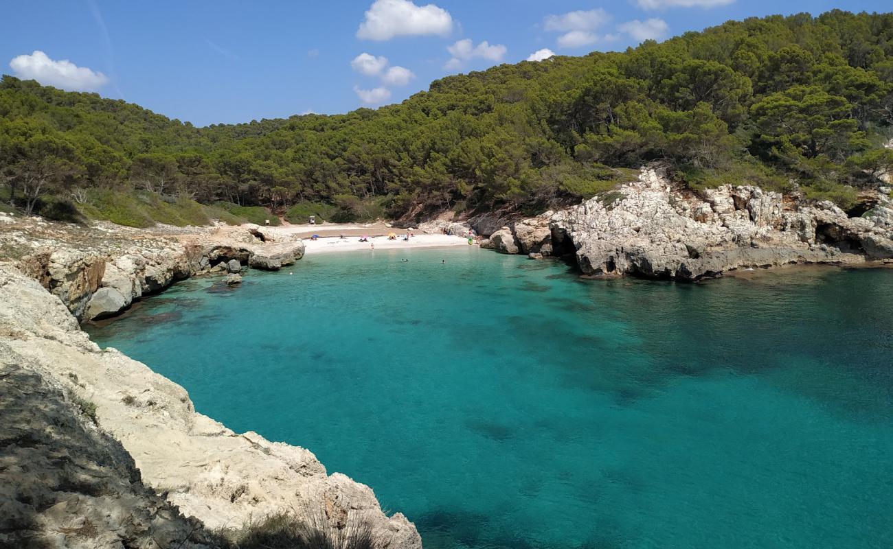 Photo of Cala Fustam with bright fine sand surface