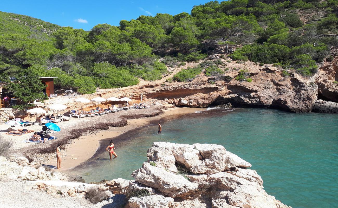 Photo of Cala Olivera with brown sand &  rocks surface