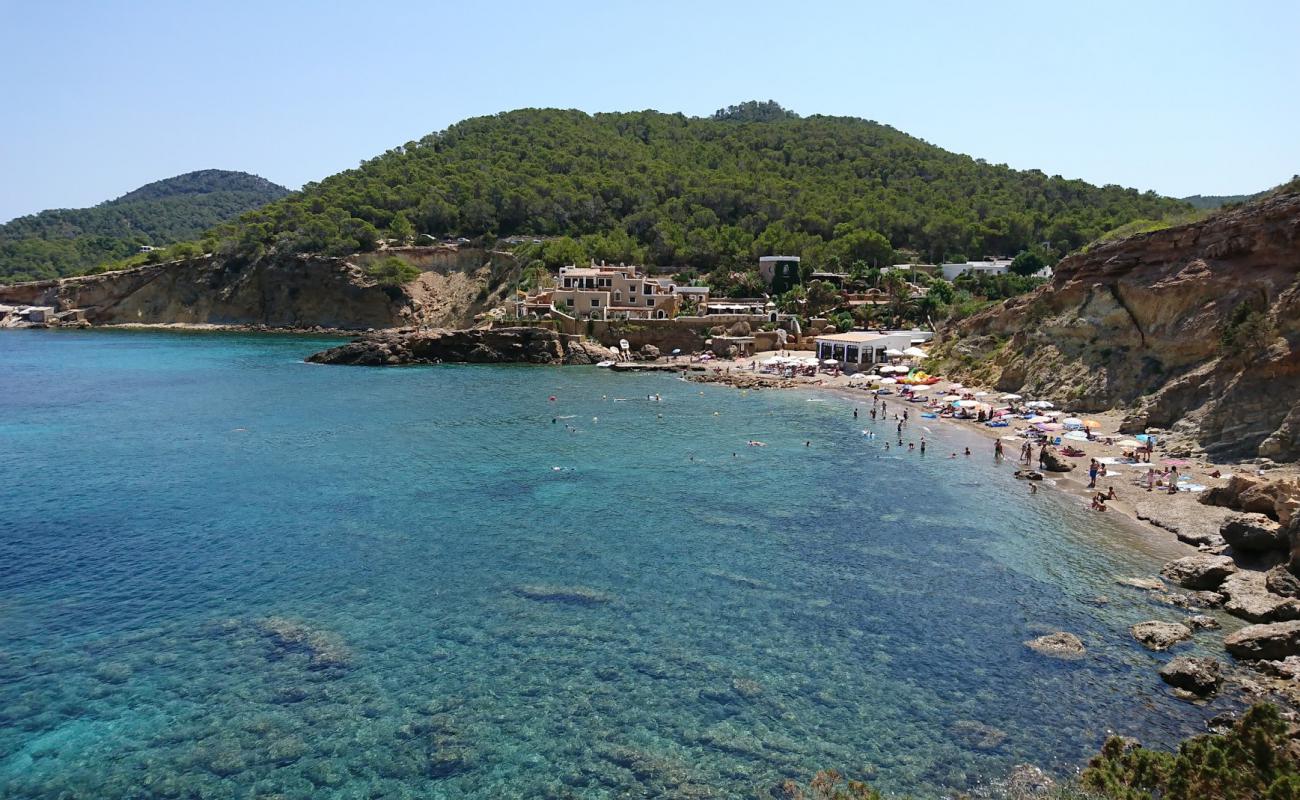 Photo of Playa Cala Xarraca with gray sand &  rocks surface