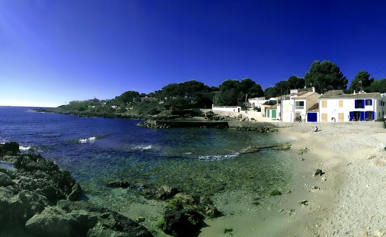 Photo of Cala Pedruscada with bright sand & rocks surface