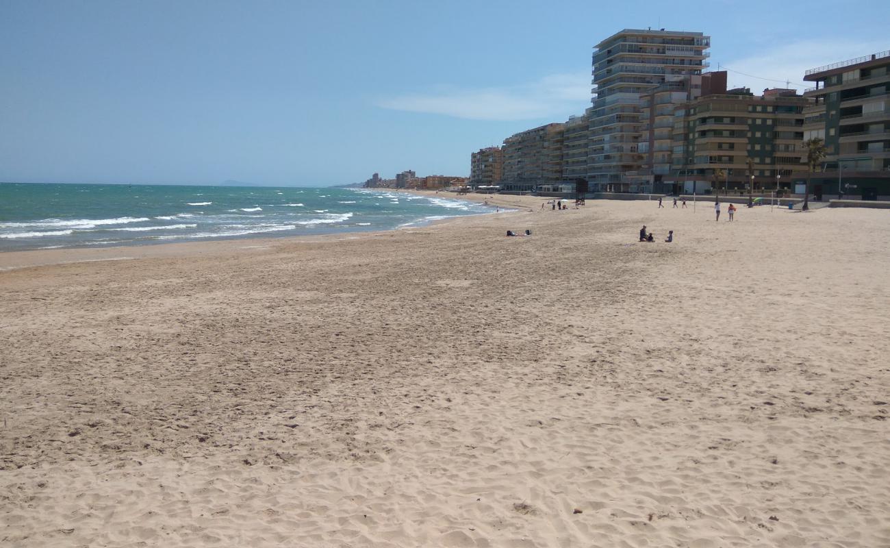 Photo of El Perellonet Beach with brown sand surface