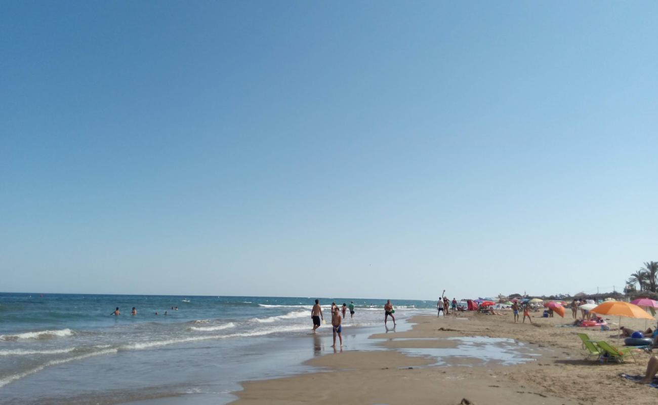 Photo of Platja de Manyetes with gray sand &  rocks surface