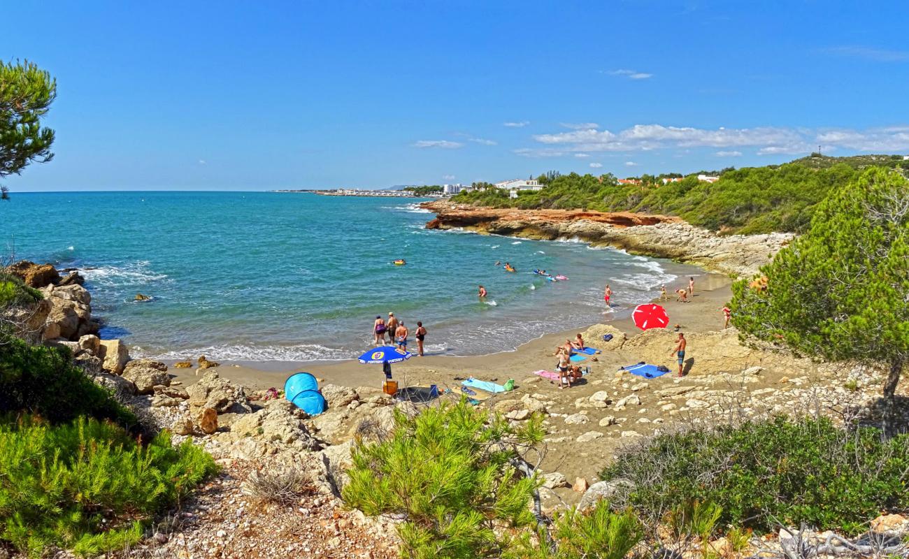 Photo of Cala Blanca with brown sand surface