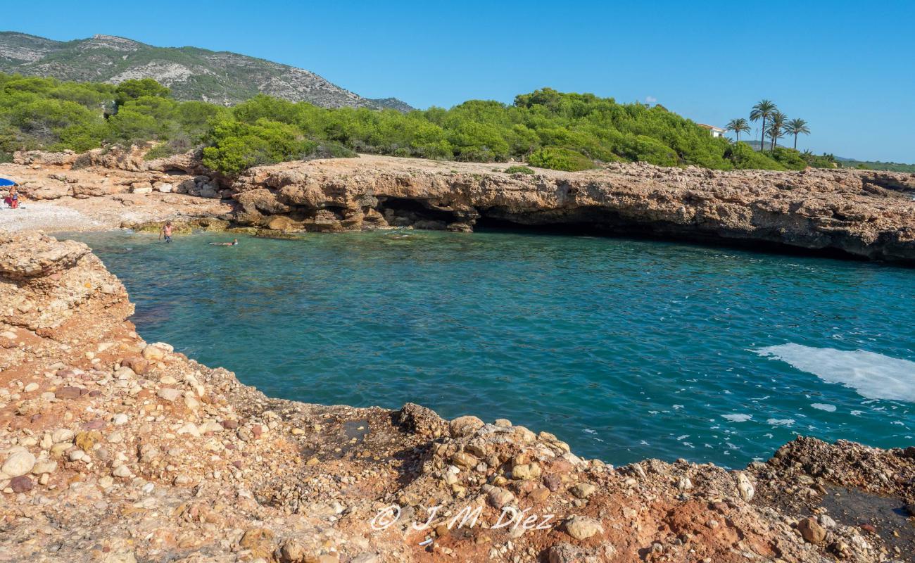 Photo of Cala Mundina with gray pebble surface