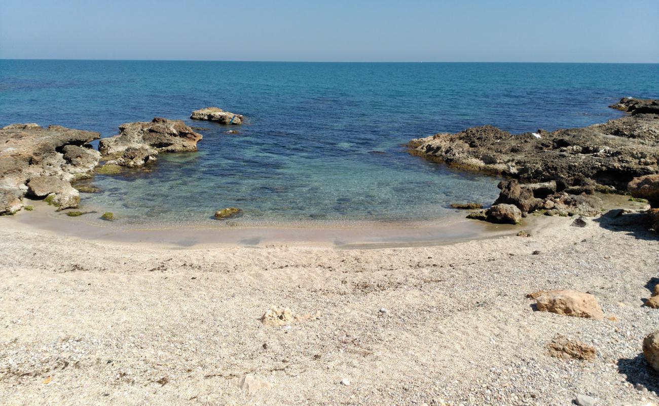 Photo of Cala del Moro with black sand & pebble surface