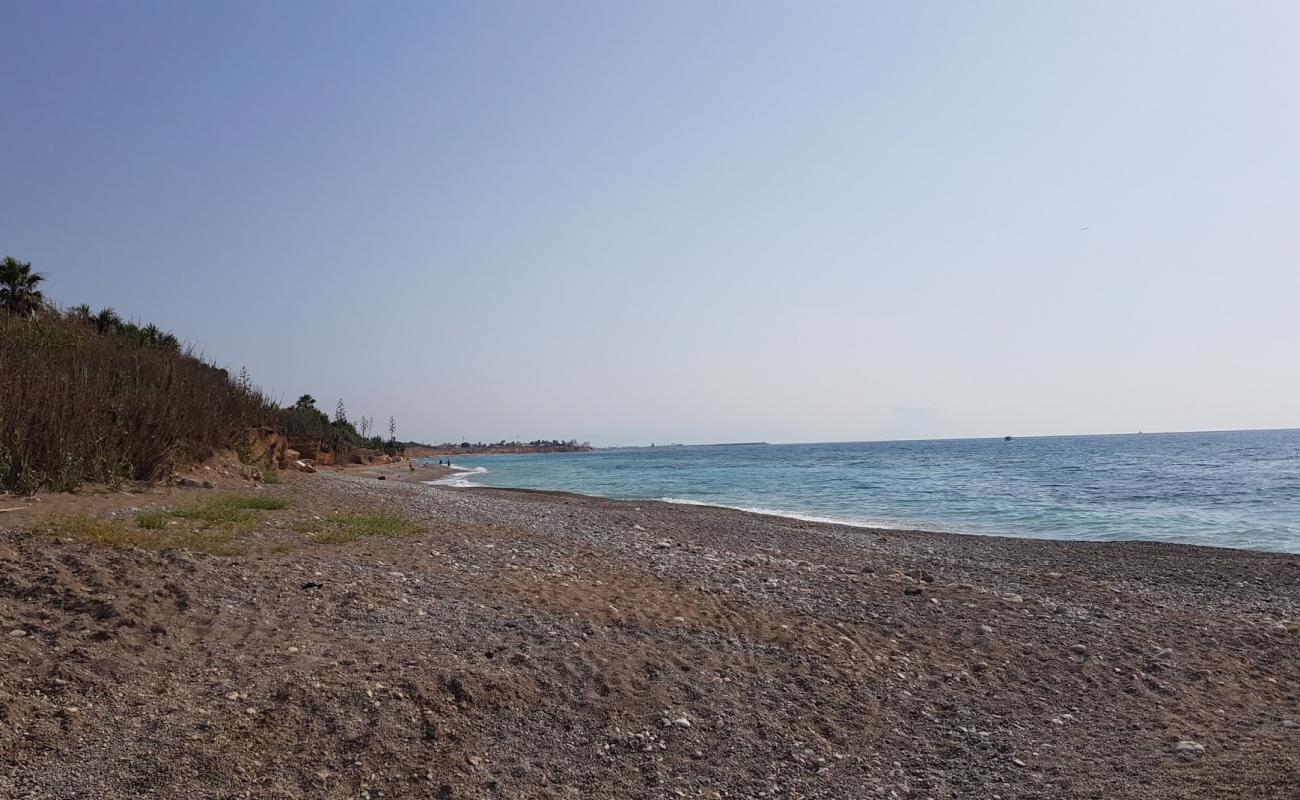 Photo of Playa Perrochos with gray pebble surface