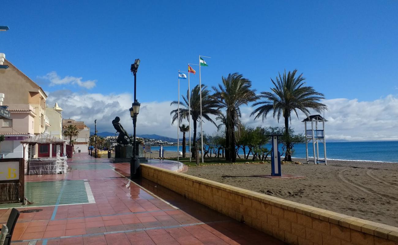 Photo of Chiringuito beach with gray shell sand surface