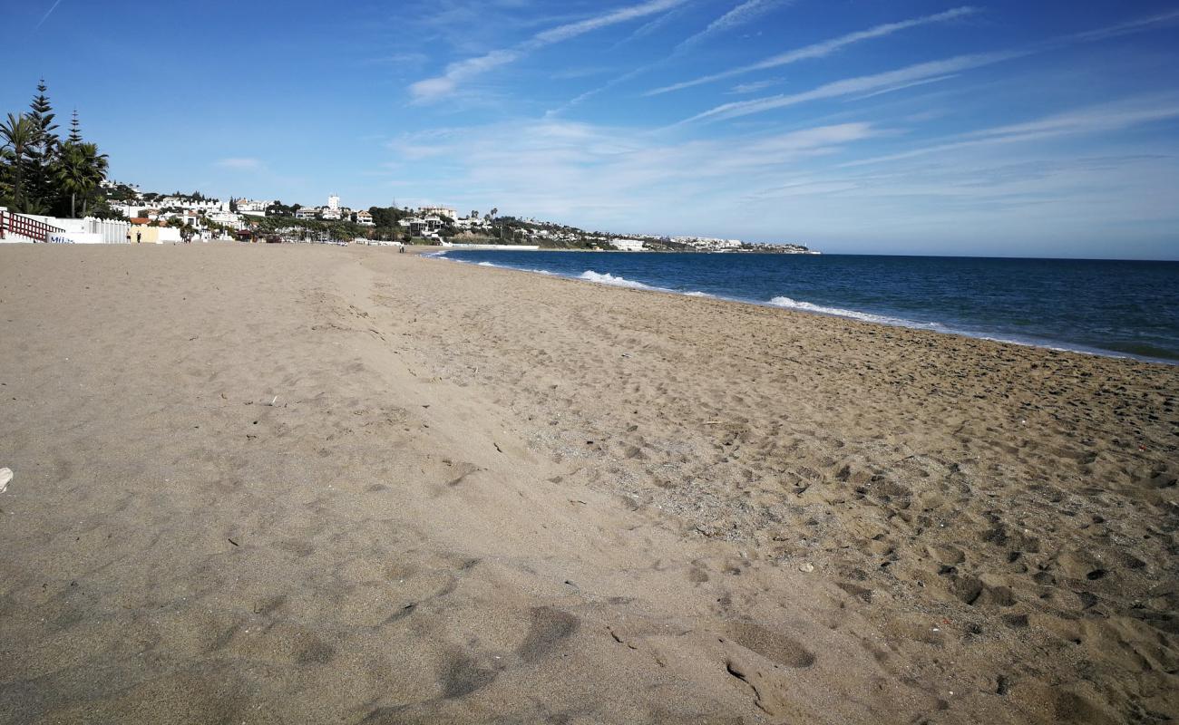 Photo of la Cala de Mijas with gray sand surface