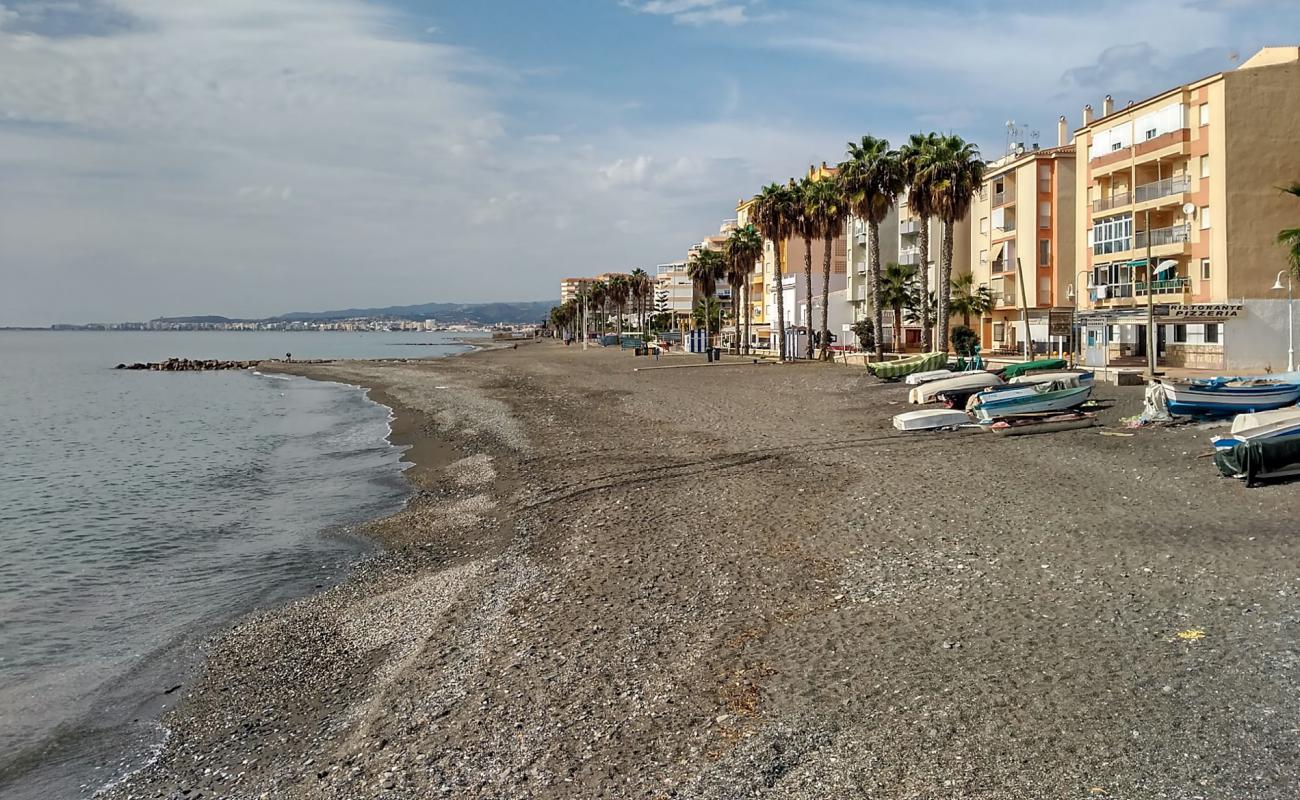 Photo of Playa de la Mezquitilla with gray sand surface