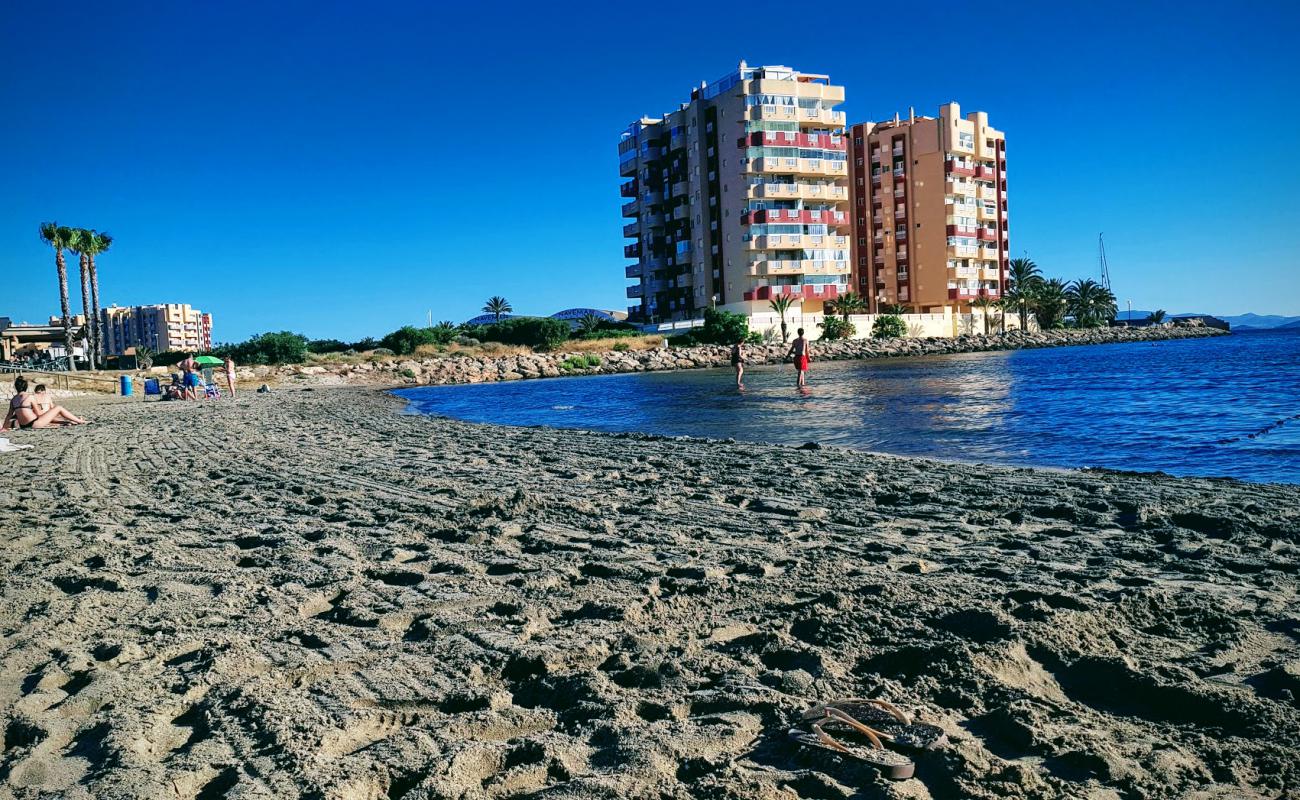 Photo of Playa Chica with gray sand surface