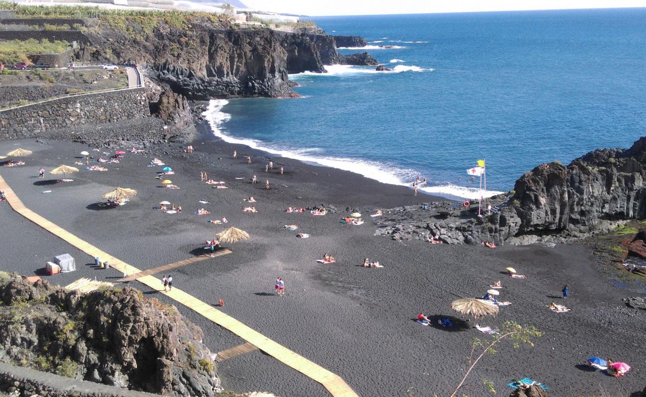 Photo of Playa de Charco Verde with black sand surface