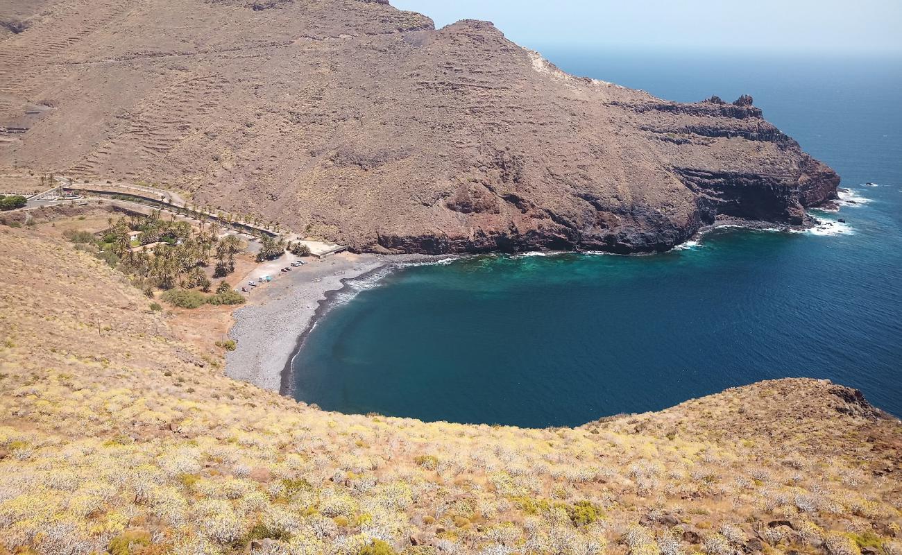 Photo of Playa de Avalo with gray sand &  rocks surface