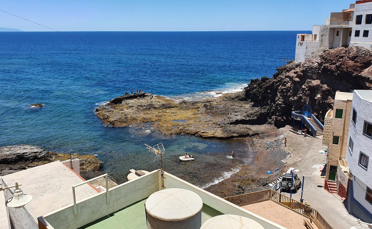 Photo of Playa de Caleta de Arriba with brown sand &  rocks surface