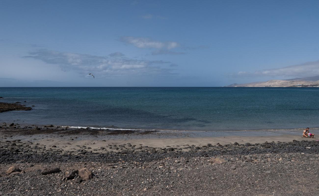 Photo of Playa de la Jaqueta with brown sand &  rocks surface