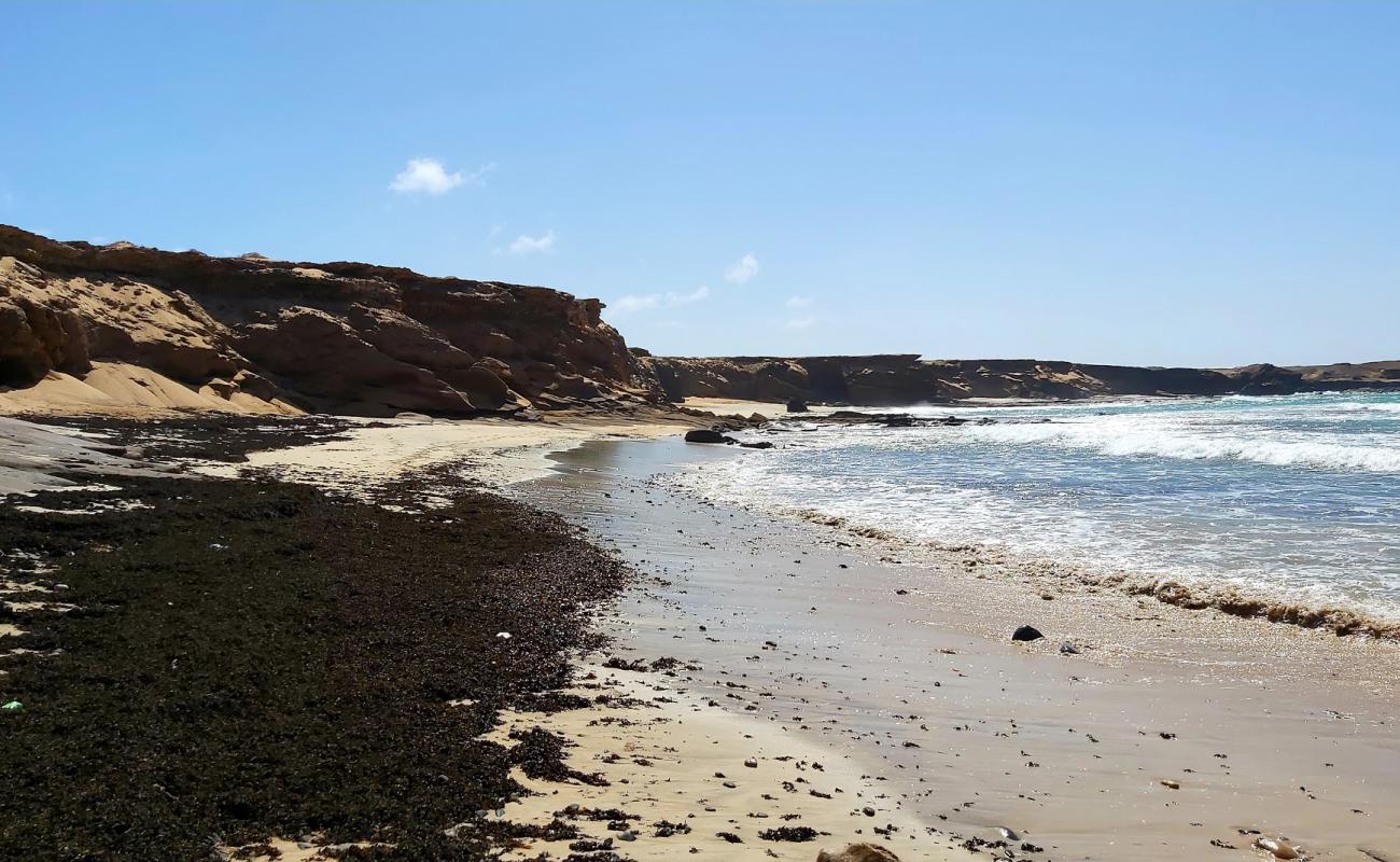 Photo of Playa de la Turbia with brown sand &  rocks surface