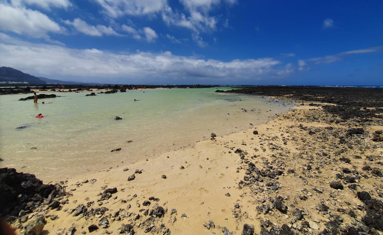 Photo of Caleton Blanco with bright sand & rocks surface