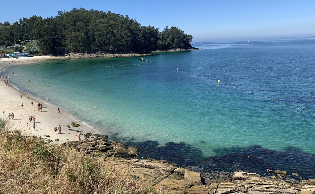 Photo of Playa de Mogor with white fine sand surface