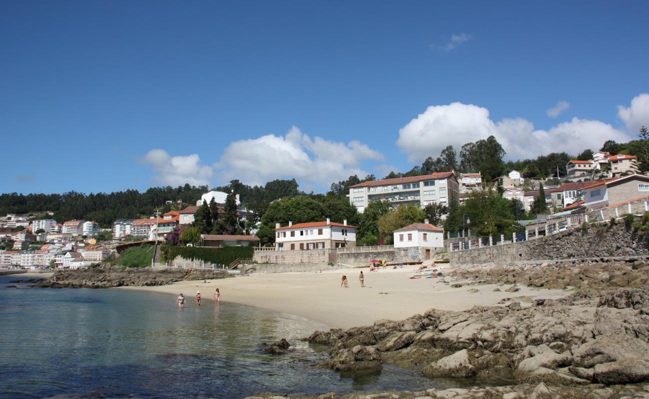 Photo of Praia de Sinas with white fine sand surface