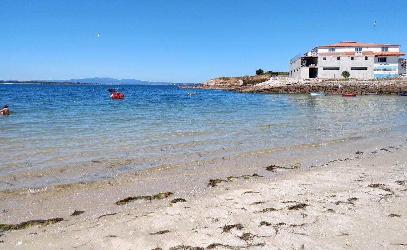 Photo of Praia de Conroibo with white sand surface