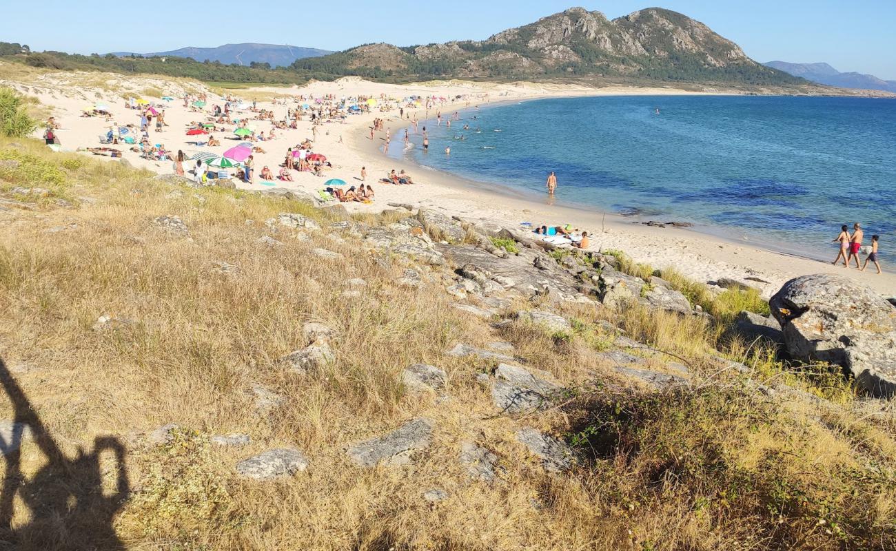 Photo of Praia de Larino with white fine sand surface