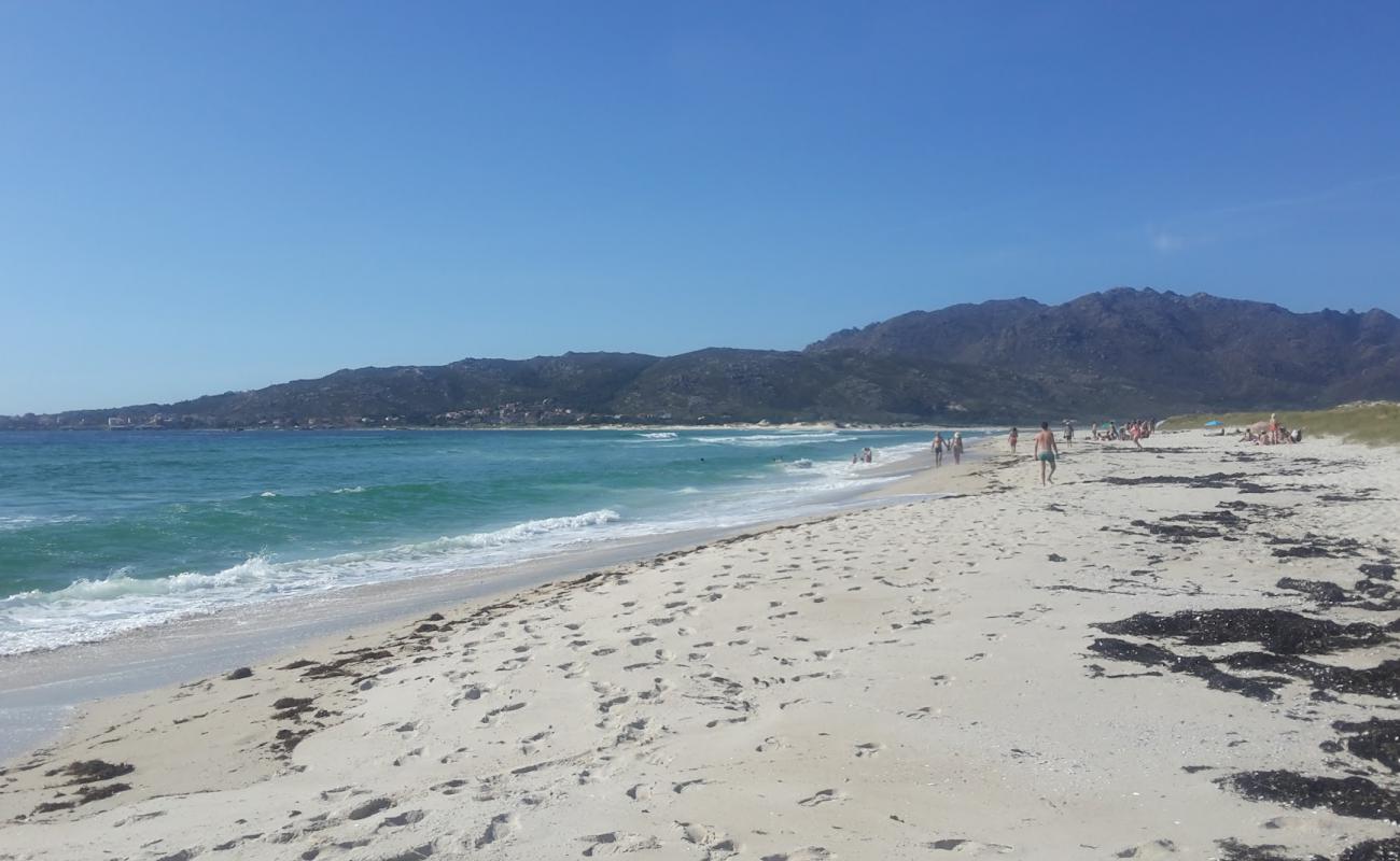 Photo of Praia de San Mamede with white fine sand surface