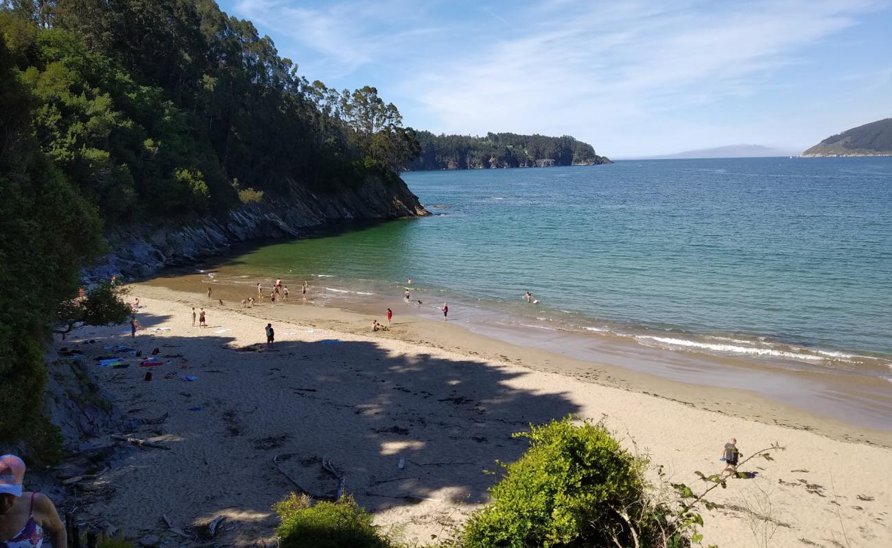 Photo of Praia de Sacido with bright fine sand surface