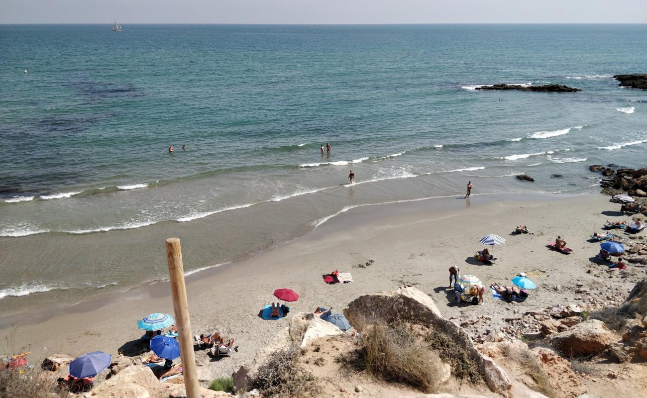 Photo of Playa Flamenca Naturista with bright sand & rocks surface