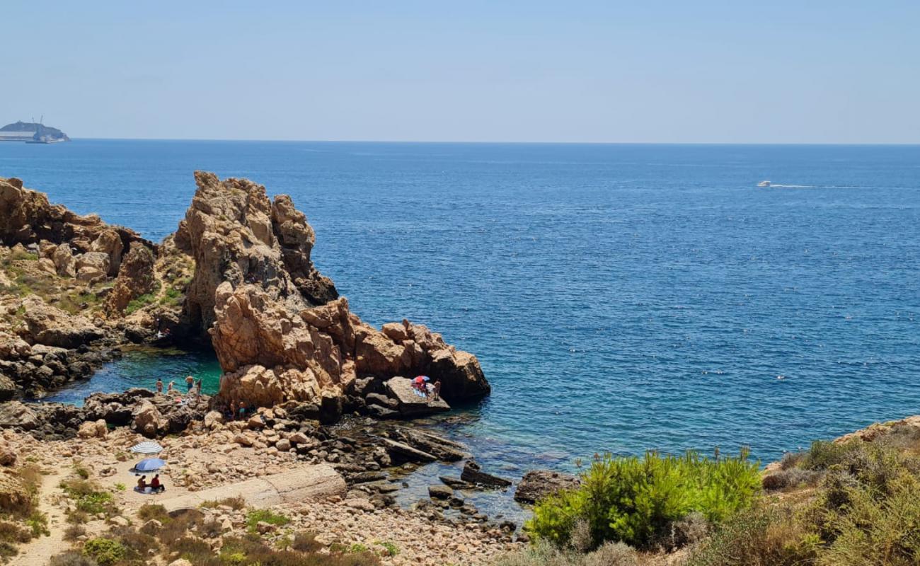 Photo of Cala del Reflector with rocks cover surface