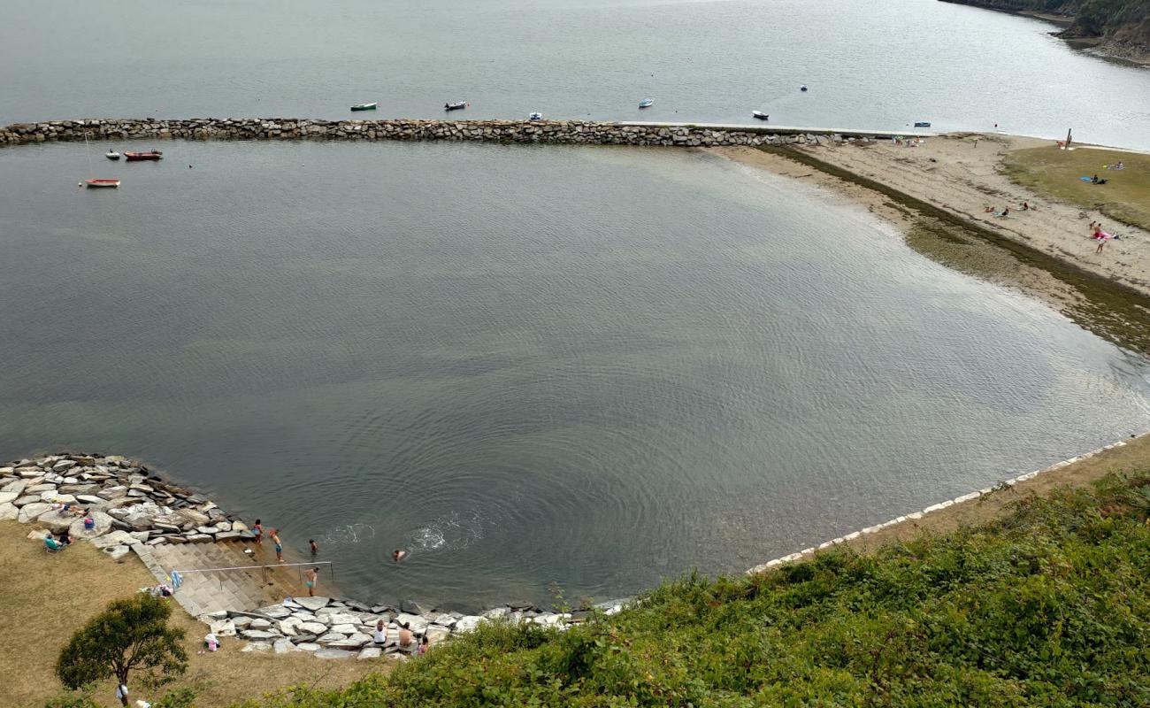 Photo of Praia dos Bloques with bright sand surface