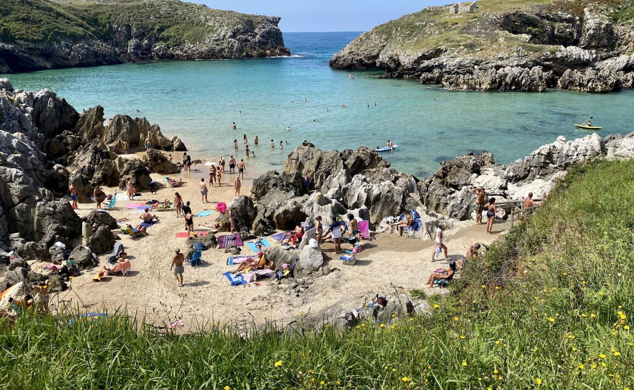 Photo of Playa de Cue with bright sand surface